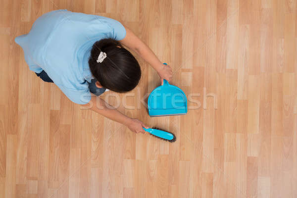 Woman Brooming Wooden Floor Stock photo © AndreyPopov