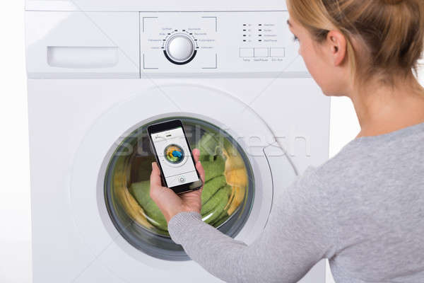 Frau Handy Waschmaschine Rückansicht weiß Stock foto © AndreyPopov