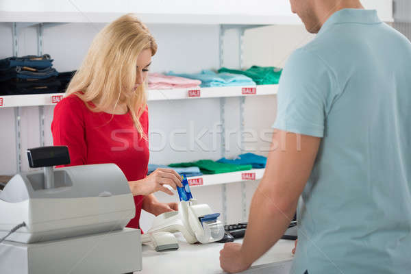 Cashier Using Credit Card While Standing With Customer Stock photo © AndreyPopov