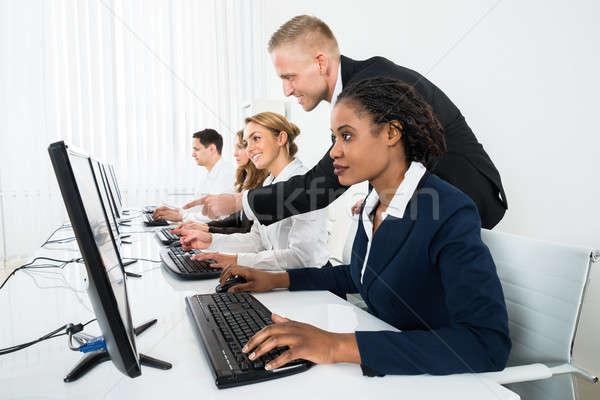 Manager Assisting His Staff In Office Stock photo © AndreyPopov