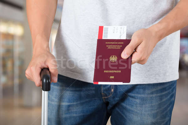Person With Luggage Holding Passport And Boarding Pass Tickets Stock photo © AndreyPopov