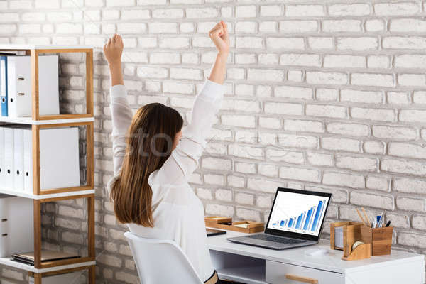 Successful Businesswoman Sitting On Chair Raising Her Hands Stock photo © AndreyPopov