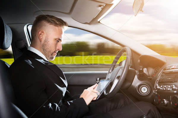 Businessman Sitting Inside Self Driving Car Stock photo © AndreyPopov