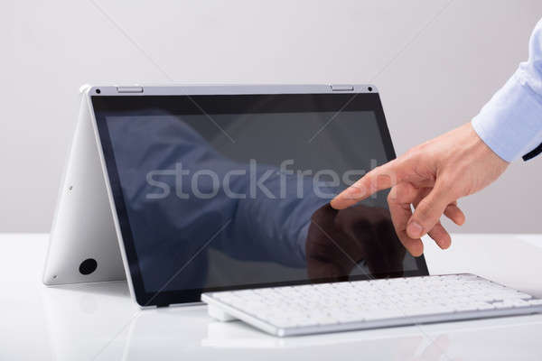 Işadamı dokunmak parmak melez dizüstü bilgisayar ekran Stok fotoğraf © AndreyPopov