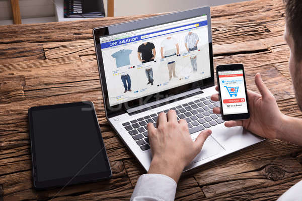 üzletember okostelefon vásárlás online laptop közelkép Stock fotó © AndreyPopov
