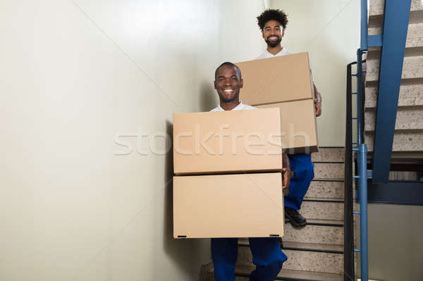Portrait Of Two Movers Holding Cardboard Boxes Stock photo © AndreyPopov