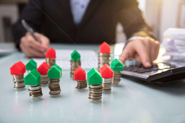 Close-up Of Green And Red House Model On Stacked Coins Stock photo © AndreyPopov