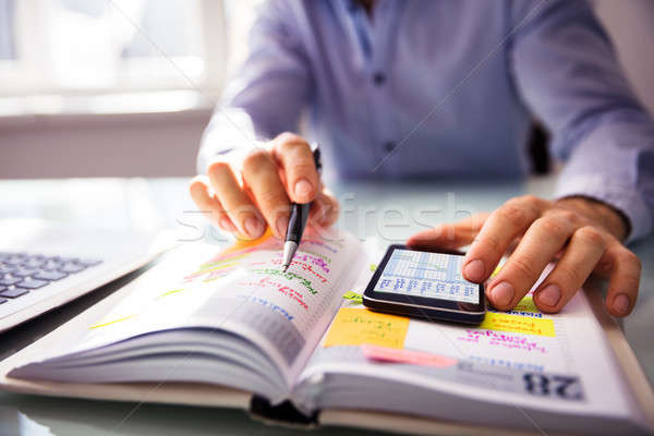 Businessperson Writing Schedule In Diary Stock photo © AndreyPopov