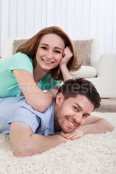 Stock photo: Happy Young Couple Lying On Front