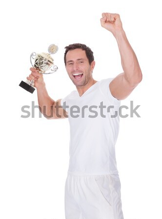Jubilant winner holding up the trophy Stock photo © AndreyPopov