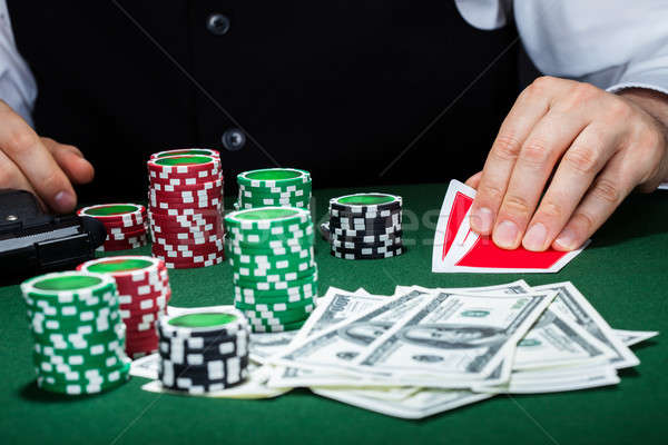 Portrait of a croupier looking at playing cards Stock photo © AndreyPopov