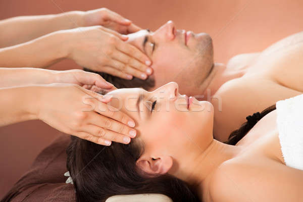 Stock photo: Relaxed Couple Receiving Head Massage At Spa