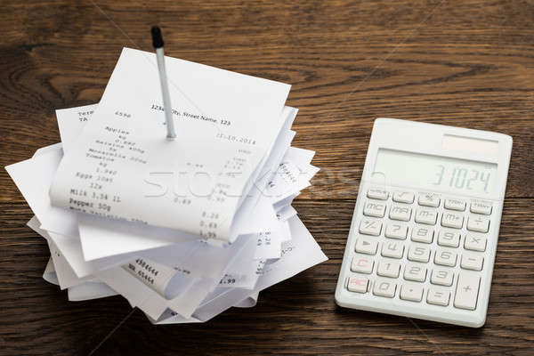 Receipts With Calculator On Table Stock photo © AndreyPopov