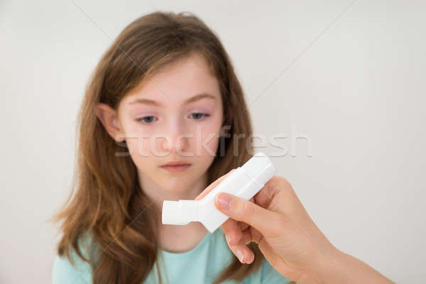 Person Hands With Inhaler In Front Of Girl Stock photo © AndreyPopov