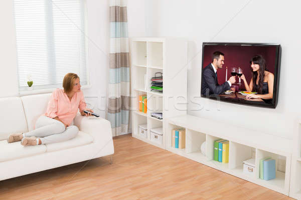Woman Watching Movie On Television Stock photo © AndreyPopov