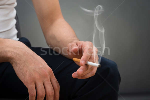 Midsection Of Man Holding Cigarette Stock photo © AndreyPopov