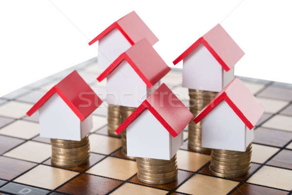 Stock photo: House Models And Stacked Coins On Chessboard