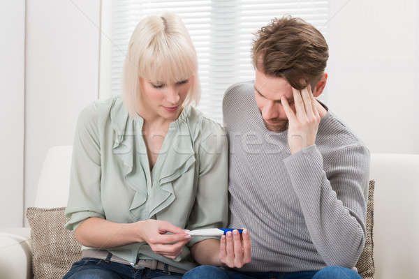 Unhappy Couple Looking At Pregnancy Tester Stock photo © AndreyPopov