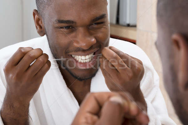 African Man Cleaning His Teeth Stock photo © AndreyPopov