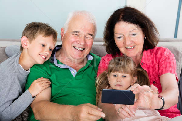 Happy Multi Generation Family Taking Picture At Home Stock photo © AndreyPopov