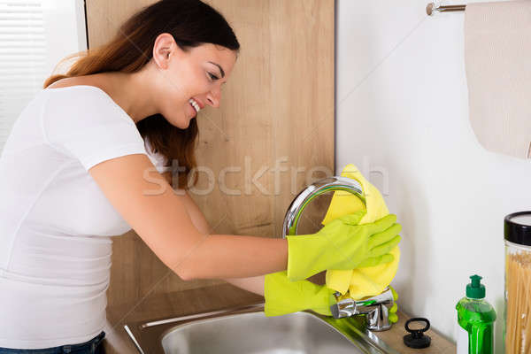 Happy Woman Cleaning The Tap Stock photo © AndreyPopov