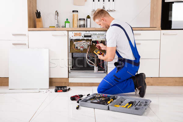 Technician Checking Dishwasher With Digital Multimeter Stock photo © AndreyPopov