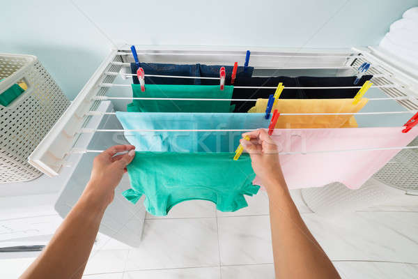 Person Hanging Wet Cloth On Clothes Line Stock photo © AndreyPopov