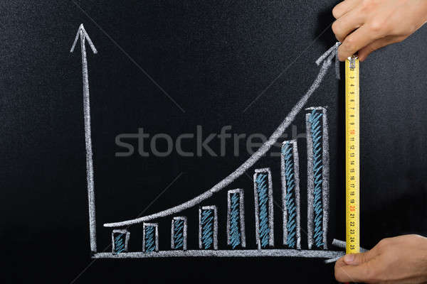Person Measuring Graph On Blackboard Stock photo © AndreyPopov