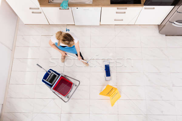 Housemaid Mopping Floor In Kitchen Stock photo © AndreyPopov