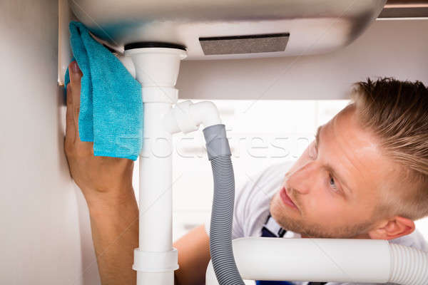 Man Repairing Sink In Kitchen Stock photo © AndreyPopov