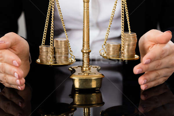 Lawyer's Hand Protecting Justice Scale With Coins Stock photo © AndreyPopov