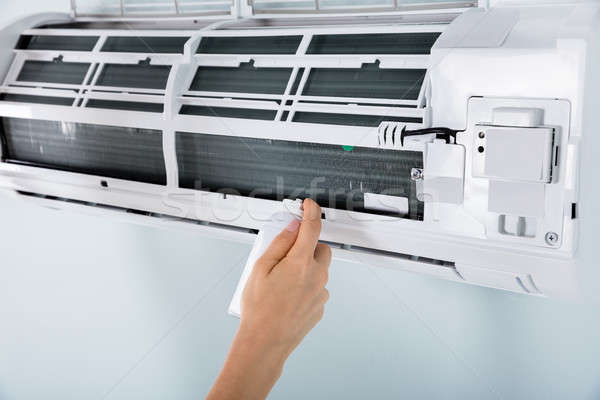 Close-up Of Person Cleaning Air Conditioner Stock photo © AndreyPopov