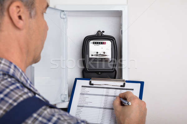 Male Technician Writing Reading Of Meter Stock photo © AndreyPopov