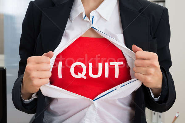 Businesswoman Tearing Off Shirt With I Quit Sign Stock photo © AndreyPopov