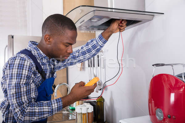 Handyman Checking Kitchen Extractor Filter Stock photo © AndreyPopov