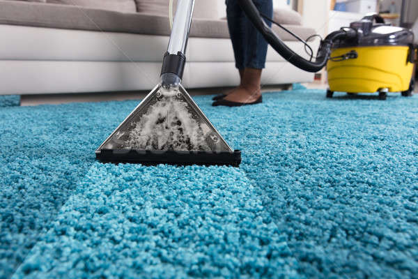 Person Using Vacuum Cleaner For Cleaning Carpet Stock photo © AndreyPopov