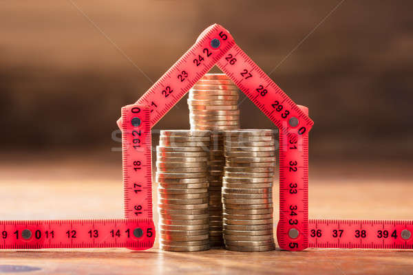 Coins Stack Under The House Made With Red Measuring Tape Stock photo © AndreyPopov