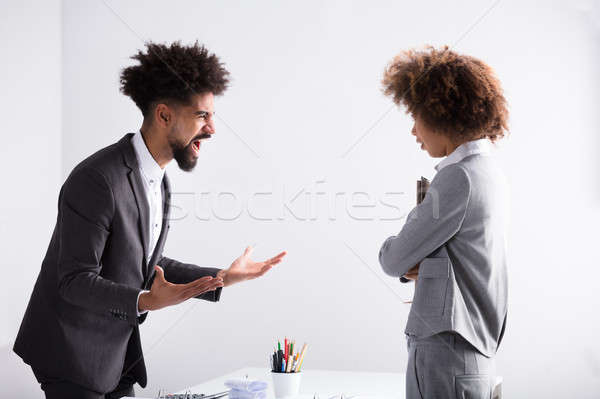 Businessman Shouting At Female Executive Stock photo © AndreyPopov