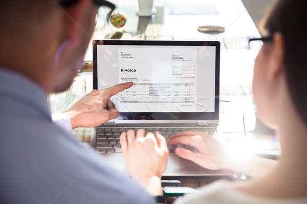 Two Businesspeople Analyzing Invoice Stock photo © AndreyPopov