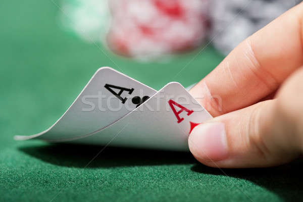Poker player checking a pair of aces Stock photo © AndreyPopov