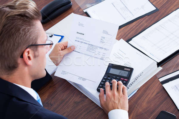 Stock photo: Businessman Using Calculator