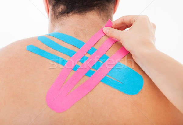Stock photo: Applying Special Physio Tape On Man's Back