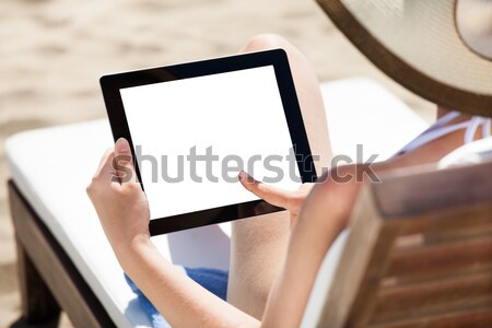 Woman Using Digital Tablet On Beach Chair Stock photo © AndreyPopov