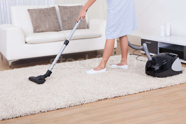 Maid Cleaning Carpet With Vacuum Cleaner Stock photo © AndreyPopov