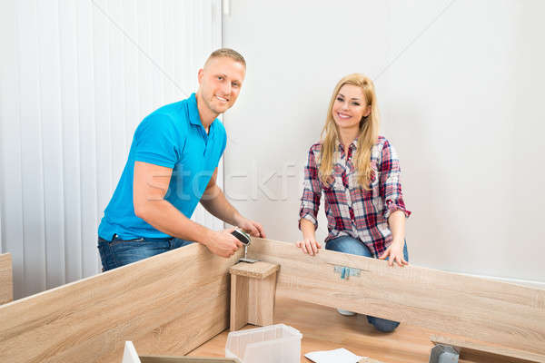 Couple Assembling Wooden Furniture Stock photo © AndreyPopov