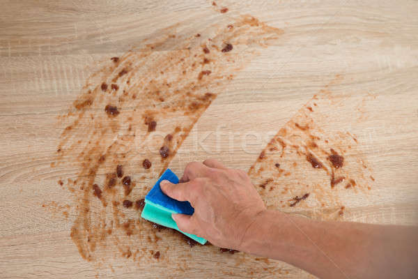 Stock photo: Man Cleaning Kitchen Counter With Sponge