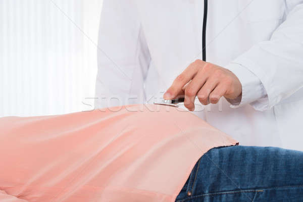 Midsection Of Doctor Examining Pregnant Woman With Stethoscope Stock photo © AndreyPopov