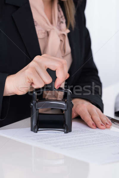 Stock photo: Businessperson Using Stamper On Document