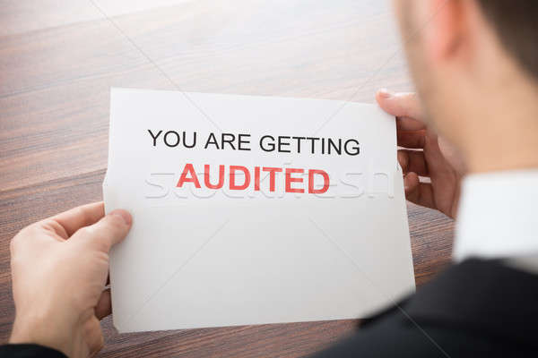 Stock photo: Businessman Opening Audit Letter In Office