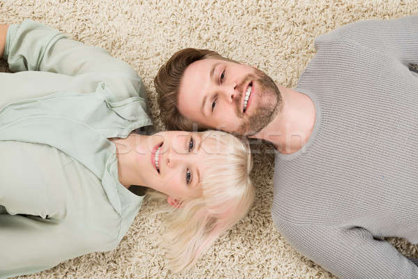 Happy Couple Lying On Carpet Stock photo © AndreyPopov
